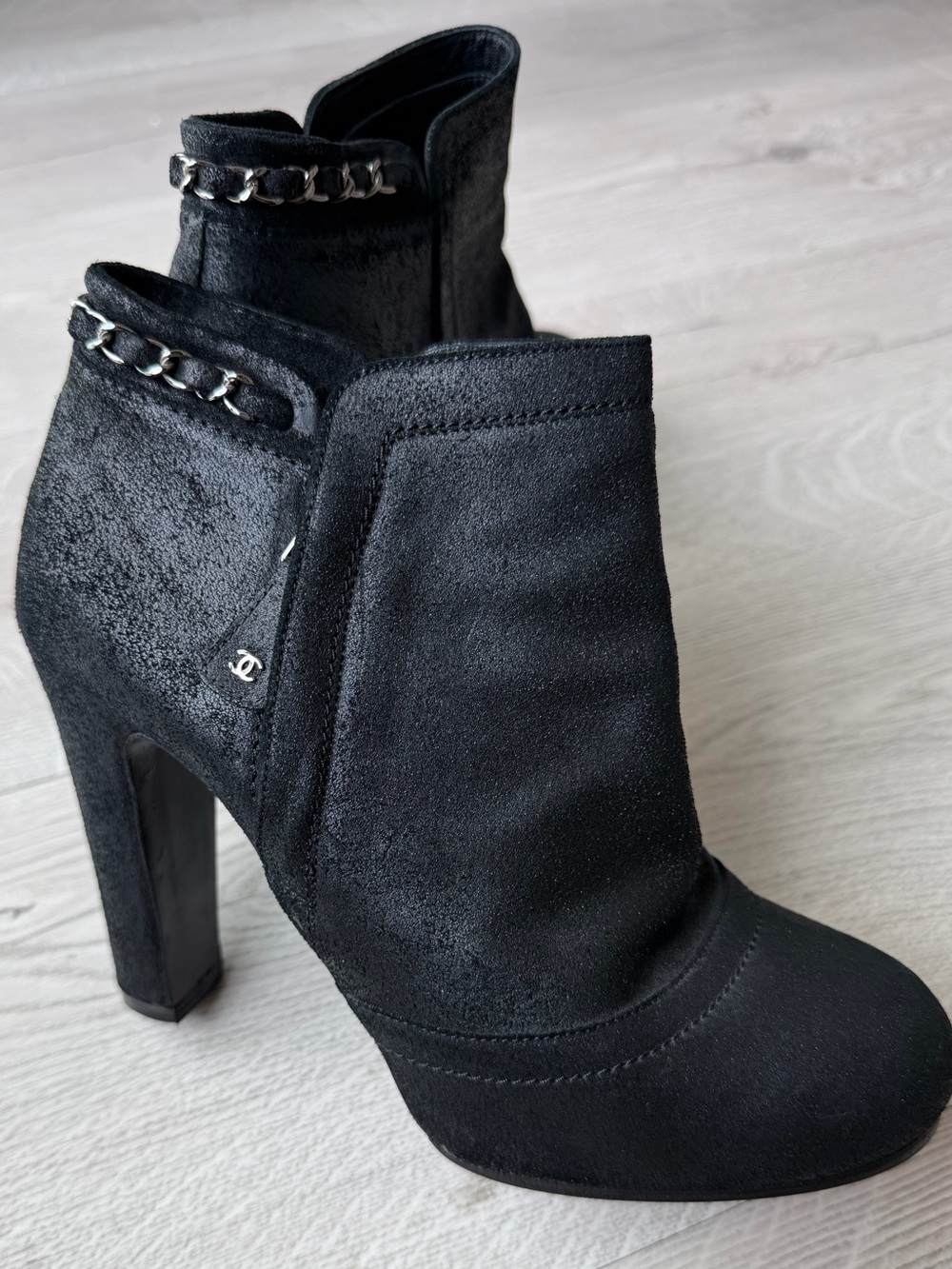 CHANEL Black Suede Heeled Ankle Boots with Chain Accent